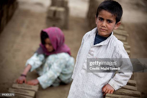 Afghan children sorts bricks at the Sadat Ltd. Brick factory, where they work from 8am to 5 pm daily, on May 14, 2010 in Kabul, Afghanistan. Child...