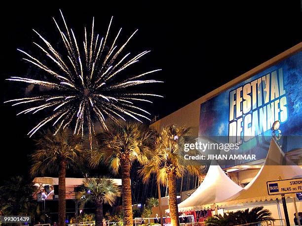 Fireworks explode over the film festival palace in Cannes, late 22 May 2004, at the end of the 57th Cannes Film Festival in the French Riviera town....
