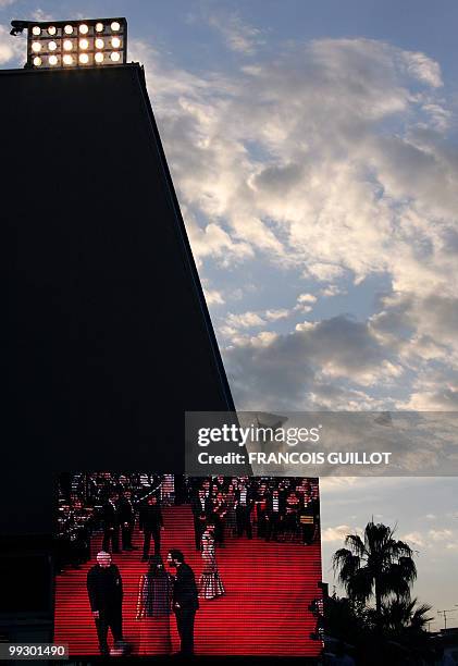 Giant screen outside the Festival's Palace shows people arriving for the screening of French director Christian Carion's film "Joyeux Noel" , 16 May...