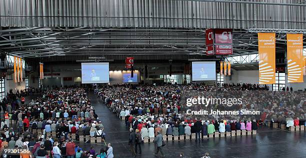 German Chancellor Angela Merkel, pictured on a giant screen delivers a speech during day 3 of the 2nd Ecumenical Church Day at International Congress...