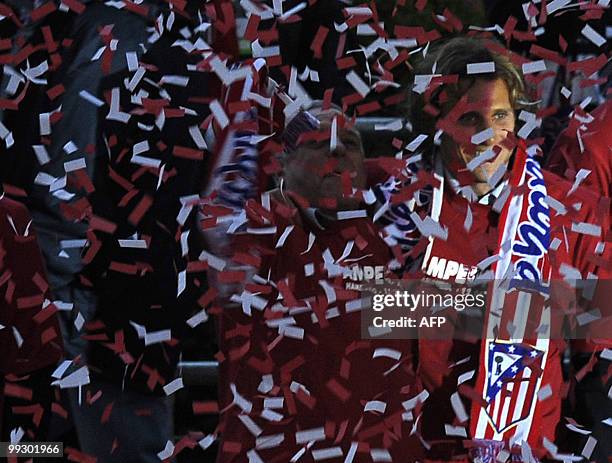 Atletico de Madrid's football player Diego Forlan arrives at the Neptune fountain in the center of Madrid on May 13, 2010 to celebrate with Atletico...