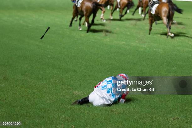 Jockey Ben So Tik-hung dislodged after finish line from horse Telecom Man during the Race 4 Carnation Handicap at Happy Valley Racecourse on July 4,...