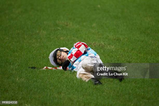 Jockey Ben So Tik-hung dislodged after finish line from horse Telecom Man during the Race 4 Carnation Handicap at Happy Valley Racecourse on July 4,...