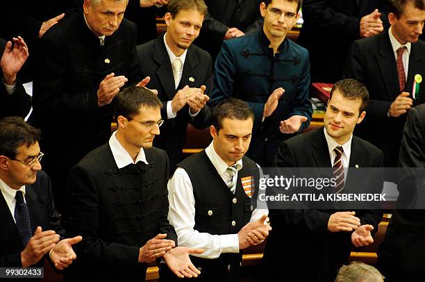 Members of the new Hungarian Parliament take their representative-oath as party leader of Hungary's far-right Jobbik party Vona Gabor , wearing an...