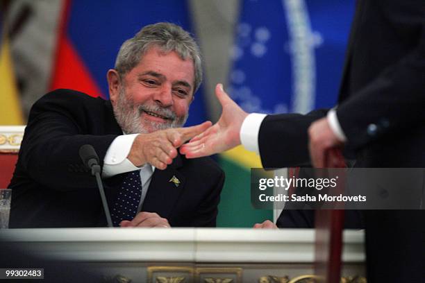 Brazilian President Luiz Inacio Lula da Silva shakes an unidentified hand during his meeting with Russian President Dmitry Medvedev at the Kremlin...