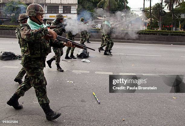 Soldiers shoot at red shirt anti-government protesters during clashes on May 14, 2010 in central Bangkok, Thailand. Protesters and military clashed...