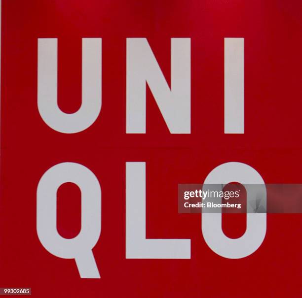 The Uniqlo brand logo hangs from Fast Retailing Co.'s flagship store in Shanghai, China, on Friday, May 14, 2010. Fast Retailing Co. Plans to...