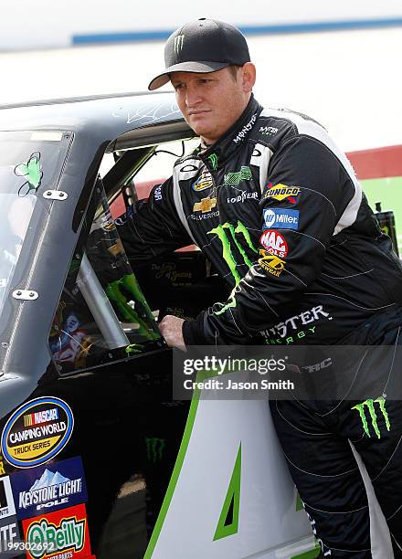 Ricky Carmichael, driver of the Monster Energy Chevrolet, stands on the grid during qualifying for the NASCAR Camping World Truck Series Dover 200 at...