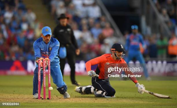 India keeper MS Dhoni breaks the stumps as Alex Hales makes his ground during the 2nd Vitality T20 International between England and India at Sophia...