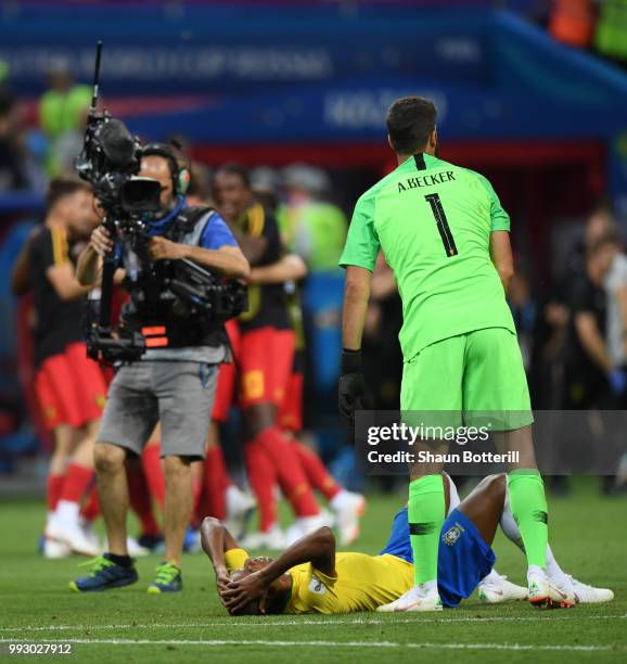 Alisson of Brazil consoles team mate Fernandinho during the 2018 FIFA World Cup Russia Quarter Final match between Brazil and Belgium at Kazan Arena...