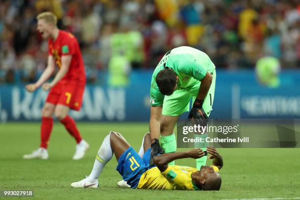 Alisson of Brazil consoles team mate Fernandinho during the 2018 FIFA World Cup Russia Quarter Final match between Brazil and Belgium at Kazan Arena...