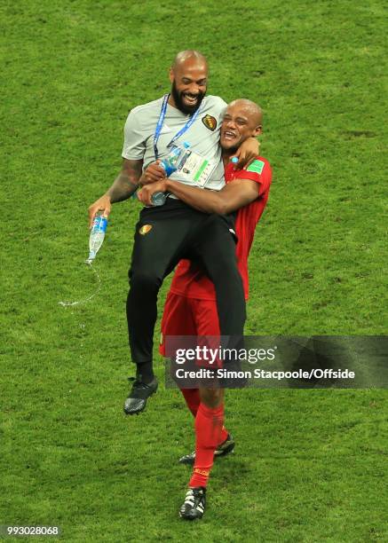 The assistant coach of Belgium Thierry Henry is lifted by Vincent Kompany of Belgium after the 2018 FIFA World Cup Russia Quarter Final match between...