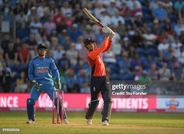 India keeper MS Dhoni looks on as Alex Hales hits a six during the 2nd Vitality T20 International between England and India at Sophia Gardens on July...