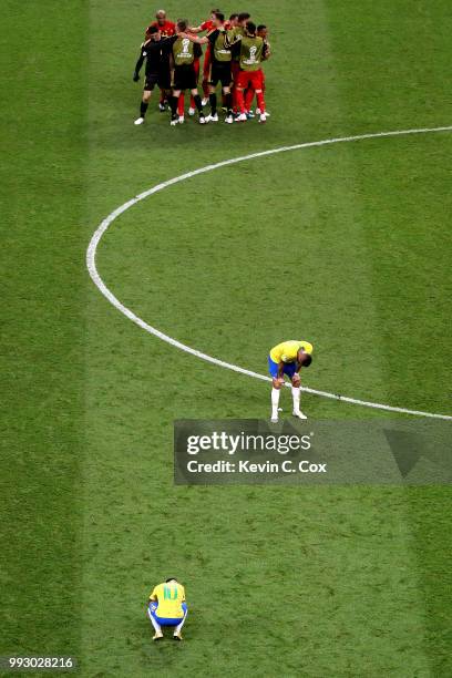 Neymar Jr and Renato Augusto of Brazil look dejected while Belgium players celebrate victory following the 2018 FIFA World Cup Russia Quarter Final...