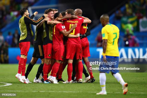 The Belgium team celebrate as Douglas Costa of Brazil looks dejected after the 2018 FIFA World Cup Russia Quarter Final match between Brazil and...
