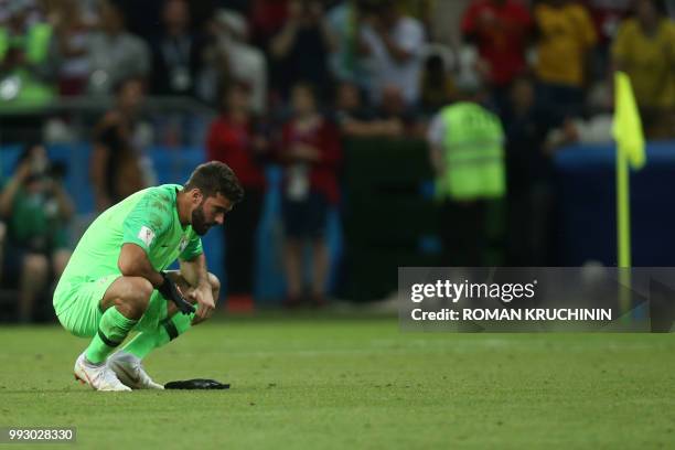 Brazil's goalkeeper Alisson reacts at the end of the Russia 2018 World Cup quarter-final football match between Brazil and Belgium at the Kazan Arena...