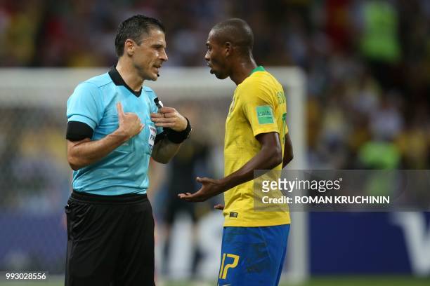 Brazil's midfielder Fernandinho argues with Serbian referee Milorad Mazic during the Russia 2018 World Cup quarter-final football match between...
