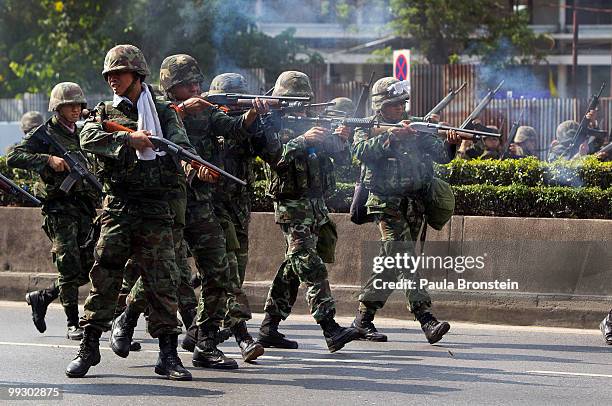 Soldiers shoot at red shirt anti-government protesters during clashes on May 14, 2010 in central Bangkok, Thailand. Protesters and military clashed...