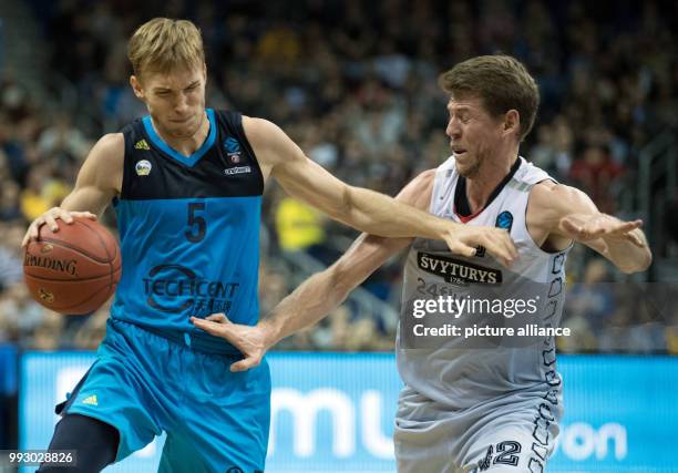 Alba's Niels Giffey and Loukas Mavrokefalidis of Vilnius vie for the ball during the Eurocup basketball match between ALBA Berlin and Lietuvos Rytas...