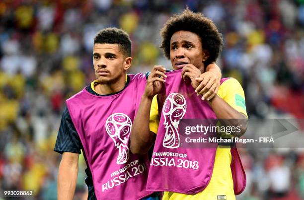 Taison of Brazil consoles teammate Willian of Brazil following their sides defeat in the 2018 FIFA World Cup Russia Quarter Final match between...