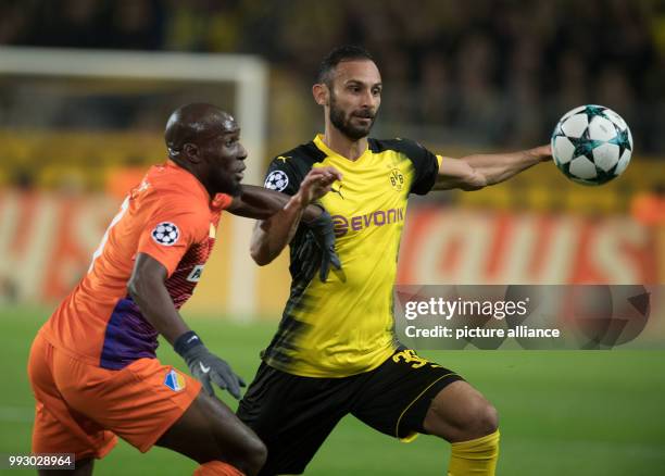 Dortmund's Oemer Toprak and Nikosia's Mickael Pote vie for the ball during the Champions League soccer match between Borussia Dortmund and APOEL...