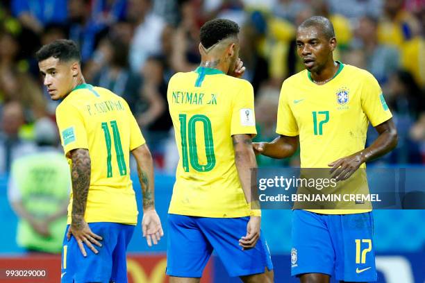 Brazil's forward Neymar talks with Brazil's midfielder Fernandinho beside Brazil's forward Philippe Coutinho during the Russia 2018 World Cup...