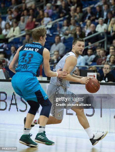 Alba's Marius Grigonis and Arturas Jomantas of Vilnius vie for the ball during the Eurocup basketball match between ALBA Berlin and Lietuvos Rytas...