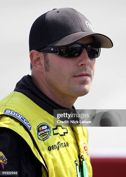 Johnny Sauter, driver of the In Country TV Chevrolet, stands on the grid during qualifying for the NASCAR Camping World Truck Series Dover 200 at...