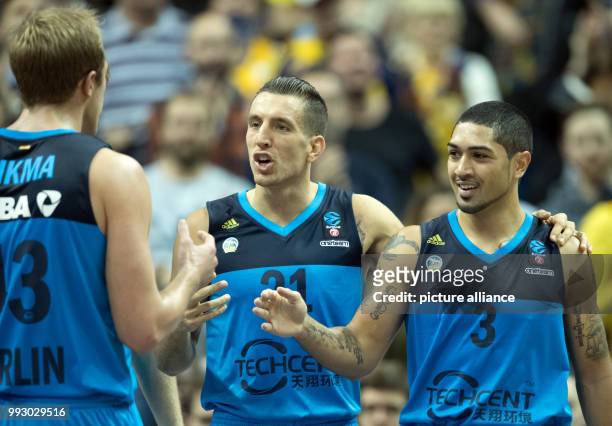 Luke Sikma , Spencer Butterfield and Peyton Siva celebrating victory after the Eurocup basketball match between ALBA Berlin and Lietuvos Rytas...