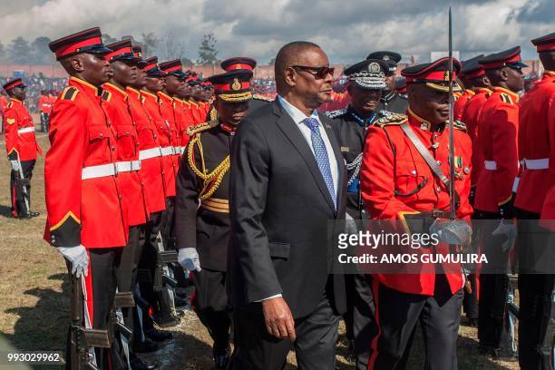 Malawi President Arthur Peter Mutharika inspects a military parade mounted by the Malawi Defence Force during national celebrations at Mzuzu Stadium...
