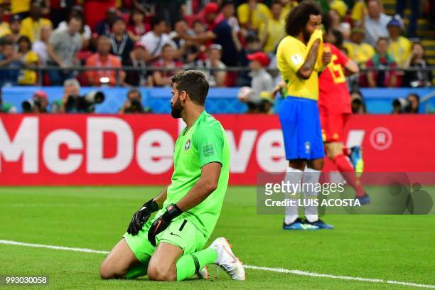 Brazil's goalkeeper Alisson reacts after taking a second goal during the Russia 2018 World Cup quarter-final football match between Brazil and...
