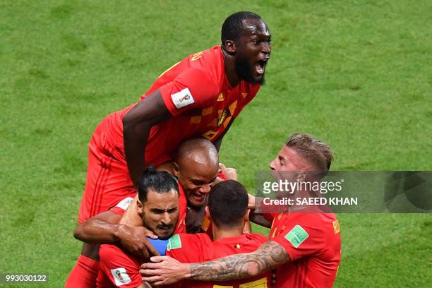Belgium's forward Romelu Lukaku jumps over teammates to celebrate Brazil's own goal during the Russia 2018 World Cup quarter-final football match...