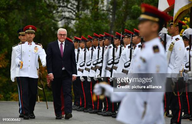 German President Frank-Walter Steinmeier being received with military honours by the President of Singapore, Halimah Jacob, in front of the Istana...