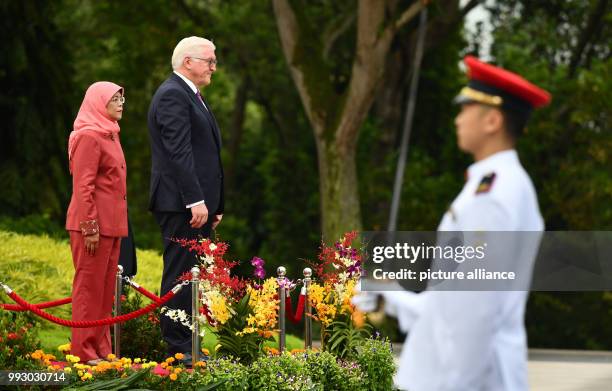 German President Frank-Walter Steinmeier being received with military honours by the President of Singapore, Halimah Jacob, in front of the Istana...