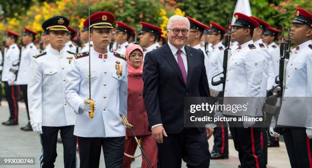 German President Frank-Walter Steinmeier being received with military honours by the President of Singapore, Halimah Jacob, in front of the Istana...