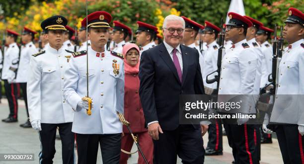 Dpatop - German President Frank-Walter Steinmeier being received with military honours by the President of Singapore, Halimah Jacob, in front of the...