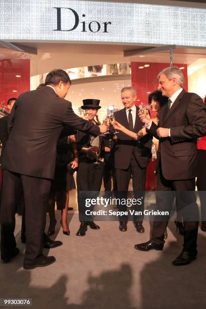 Dior designer John Galliano, LVMH chairman Bernard Arnault and Helene Arnault bring a toast to the opening of the new Dior shop in Shanghai on May...