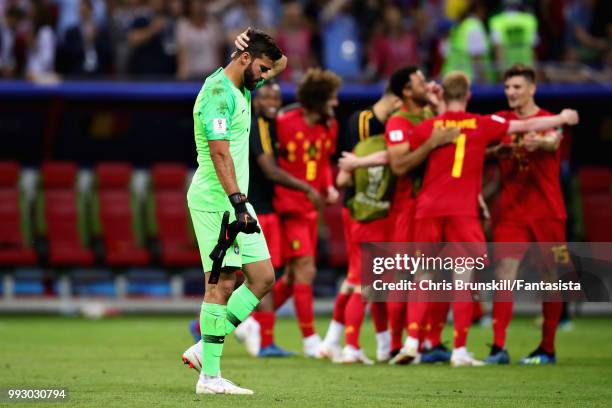 Alisson of Brazil looks dejected as the Belgium team celebrate after the 2018 FIFA World Cup Russia Quarter Final match between Brazil and Belgium at...