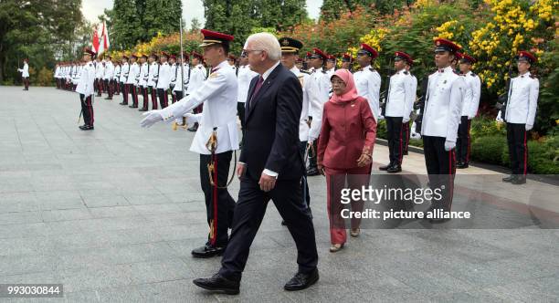 German President Frank-Walter Steinmeier being received with military honours by the President of Singapore, Halimah Jacob, in front of the Istana...