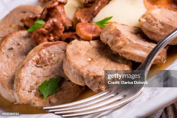 mashed potatoes with pork medallions and chanterelle sauce - mashed stock pictures, royalty-free photos & images