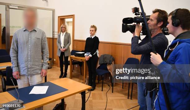 The accused, Stefan S. , standing and being filmed after entering the negotiation hall of the district court in Stade, Germany, 02 November 2017. A...