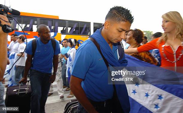 Honduran players Emilio Izaguirre and Osman Chavez come down the bus at Ramon Villeda Morales airport in San Pedro Sula, 240 km north of Tegucigalpa...