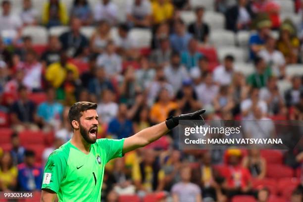 Brazil's goalkeeper Alisson speaks to his teammates during the Russia 2018 World Cup quarter-final football match between Brazil and Belgium at the...