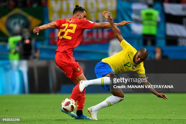 Belgium's midfielder Nacer Chadli passes the ball as he is marked by Brazil's midfielder Fernandinho during the Russia 2018 World Cup quarter-final...