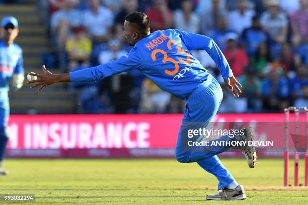 India's Hardik Pandya fields off his own bowling during the international Twenty20 cricket match between England and India at Sophia Gardens in...