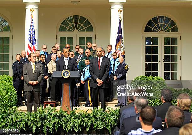 President Barack Obama speaks as Attorney General Eric Holder and President of NAPO Tom Nee listen during a Rose Garden event to honor winners of the...