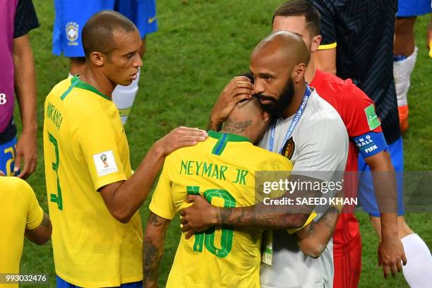 Belgium's assistant coach Thierry Henry hugs Brazil's forward Neymar at the end of the Russia 2018 World Cup quarter-final football match between...