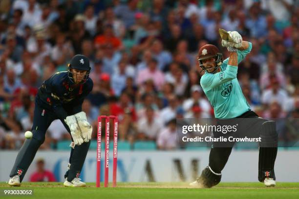 Ben Foakes of Surrey hits out while Sam Billings of Kent looks on during the Vitality Blast match between Surrey and Kent Spitfires at The Kia Oval...