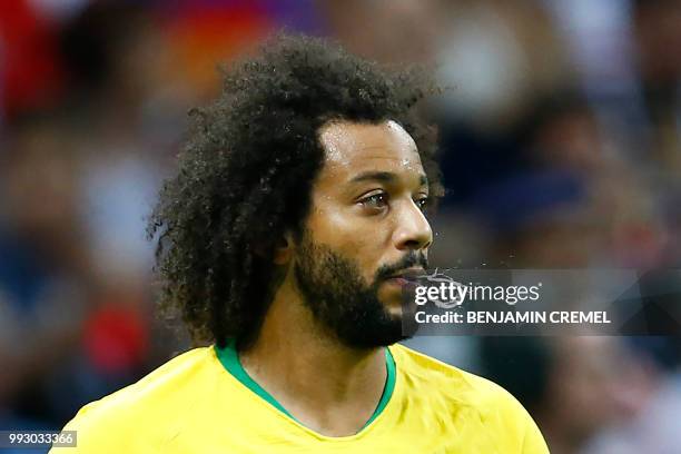 Brazil's defender Marcelo spits during the Russia 2018 World Cup quarter-final football match between Brazil and Belgium at the Kazan Arena in Kazan...