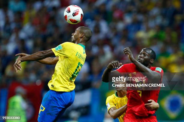 Brazil's defender Miranda holds Belgium's forward Romelu Lukaku as Brazil's midfielder Fernandinho heads the ball during the Russia 2018 World Cup...